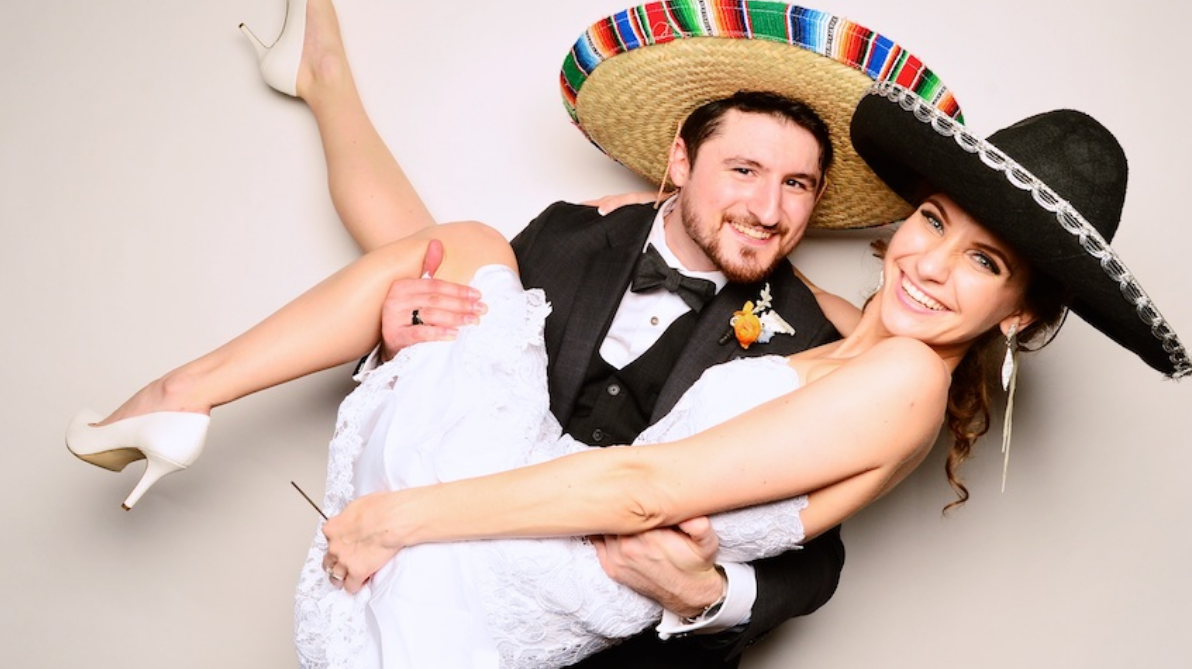 Couple with Sombreros at The Photo Station by Nate Messarra Photography, a photo booth in Houston