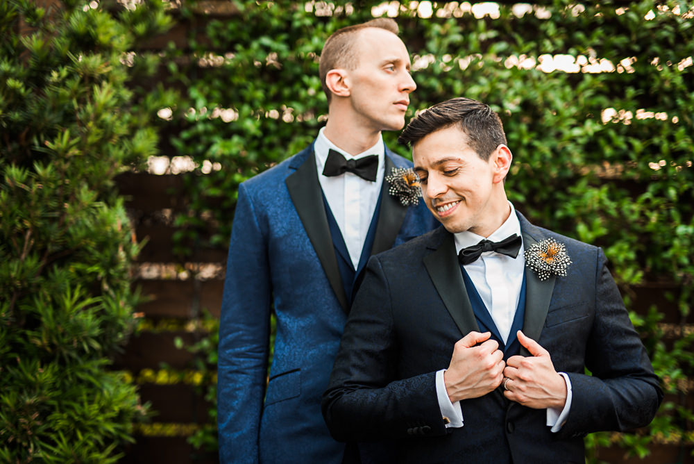 Two grooms looking in different directions on their wedding day by Houston Wedding Photographers & Videographers Nate Messarra Photography